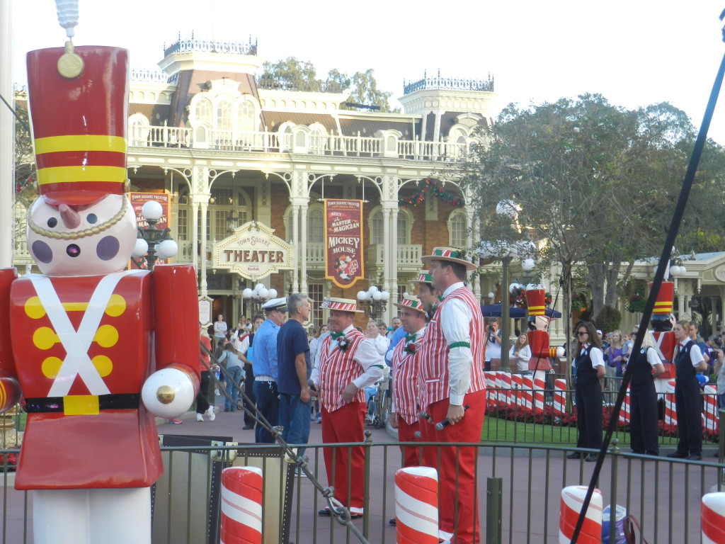 Christmas at Disney World with the Dapper Dans in red and white peppermint outfits. Keep reading to learn about the best things to do at Disney World for Christmas. Photo copyright ThemeParkHipster.