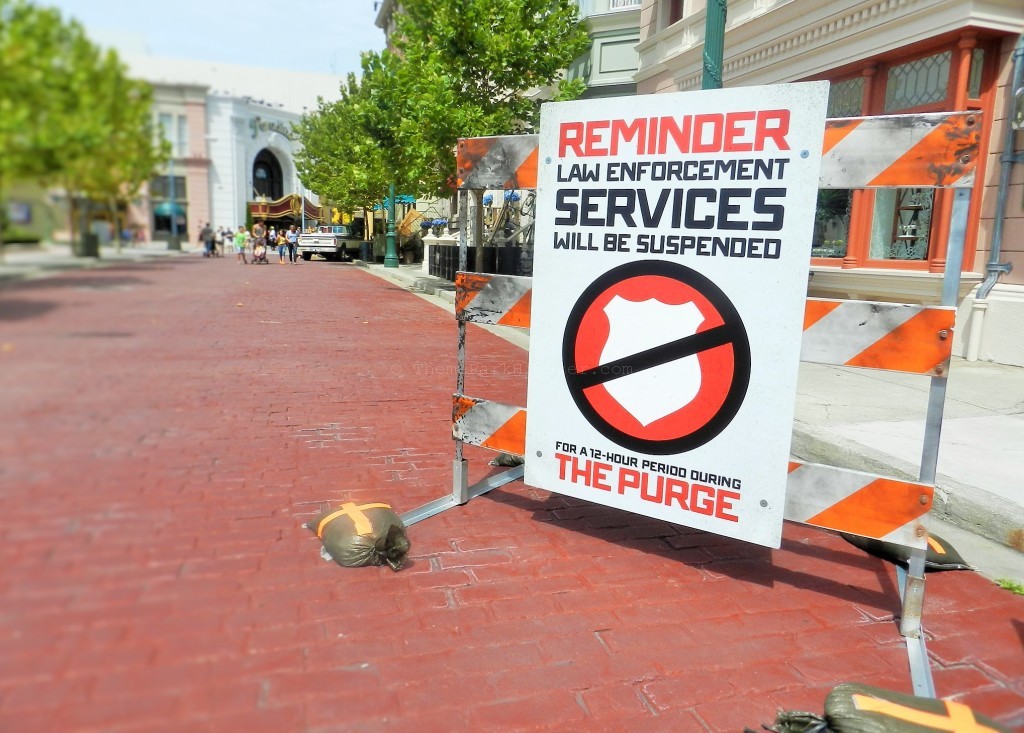 Halloween Horror Nights Purge orange and white sign. Keep reading to know what Halloween Horror Nights mistakes to avoid