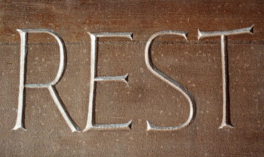 REST spelled out on the sand. Keep reading to get the best ways to beat the summer Florida heat. 