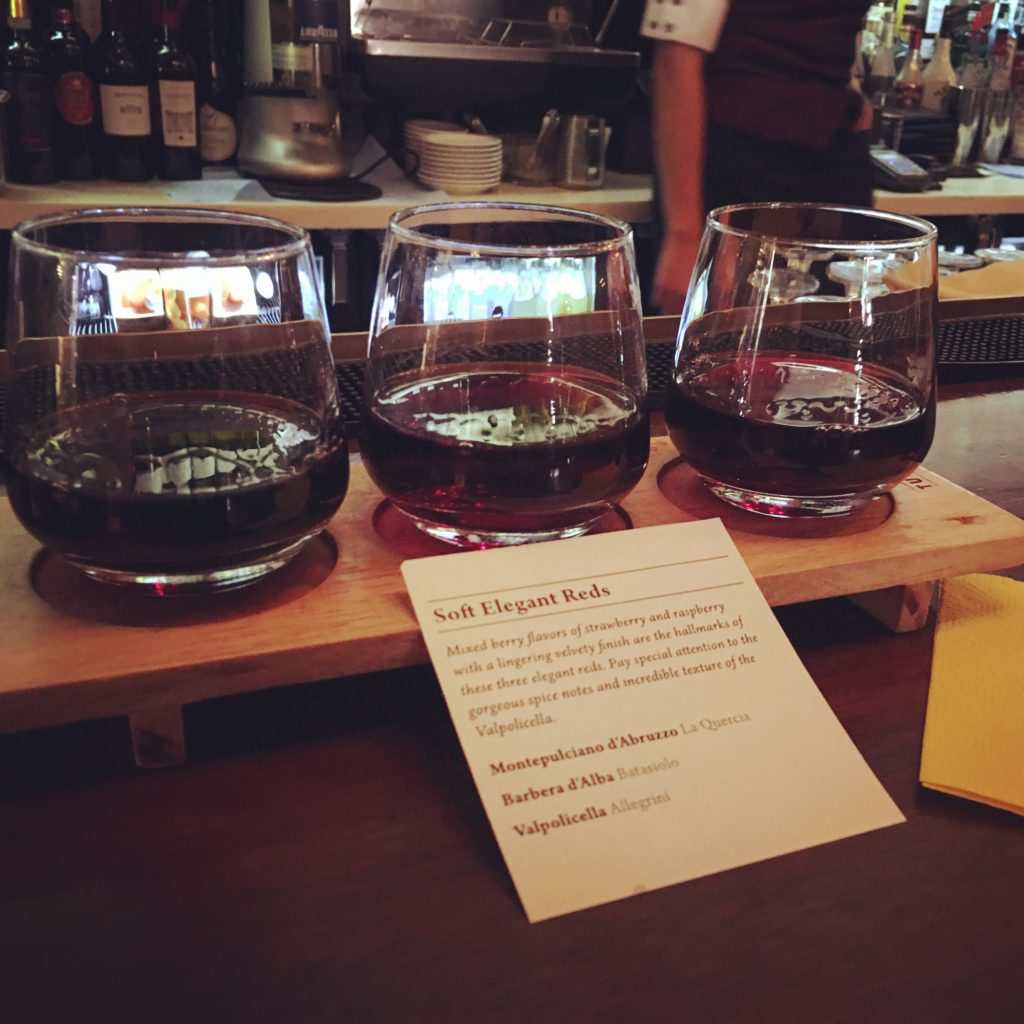 Wine Flight in Italy Pavilion at Epcot. Red wine at Walt Disney World. One of the best drinks at Epcot for Drinking Around the World.