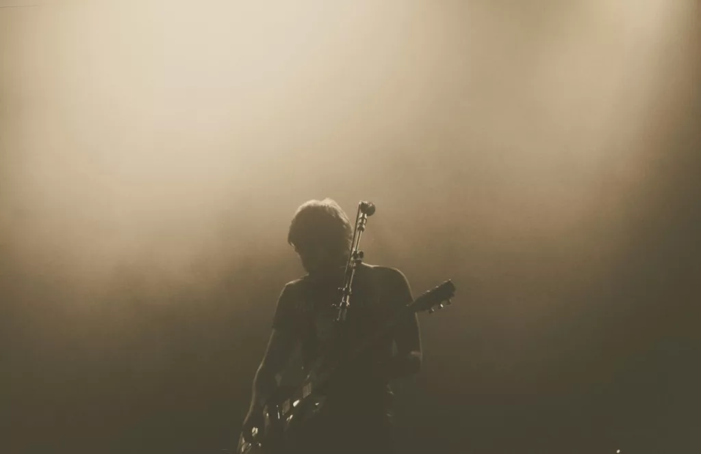 Concert with guy in the foggy shadow playing guitar. Keep reading for all you need to know about Velvet Sessions at Universal Orlando. 