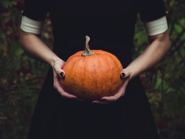 Halloween in Orlando with lady holding Pumpkin.