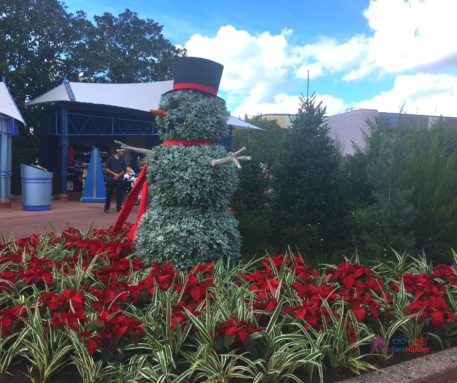 Epcot Festival of the Holidays Park Entrance with Topiary Snowman Holiday Decor celebrating Christmas at Epcot.