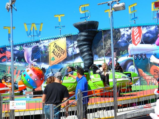 Florida State Fair Twister Ride with Green Cars. Keep reading to get the full Florida State Fair Guide with Tickets, Food, Concerts, Rides and More!