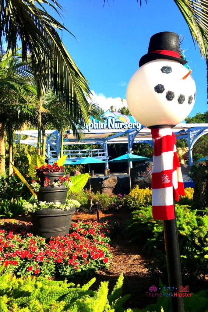 SeaWorld Christmas Celebration with Snowman Light Fixture next to Dolphin Nursery. Keep reading to learn how to have a Solo Trip to SeaWorld and how to travel alone with anxiety.