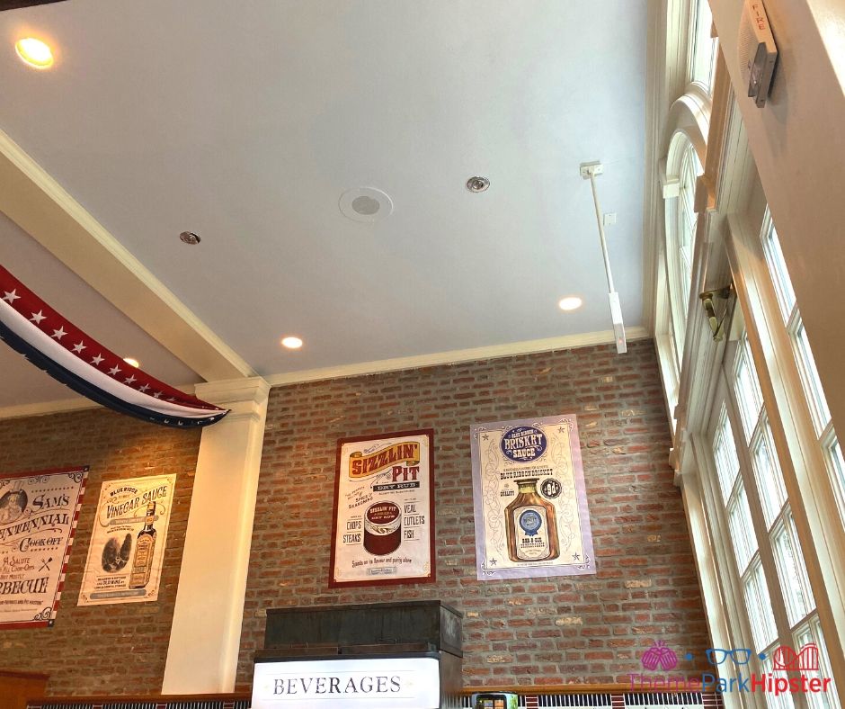 Regal Eagle Smokehouse at Epcot interior decor with brick wall and beverage center.