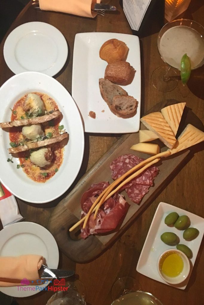 Tutto Gusto Wine Cellar in Italy Pavilion at Epcot Charcuterie Board with meatballs olives and Italian margarita