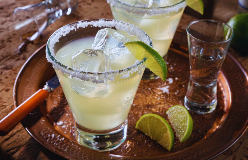 Margarita with salted rim and lime wedges. Keep reading to find out all you need to know about Dockside Margaritas at Disney Springs. 