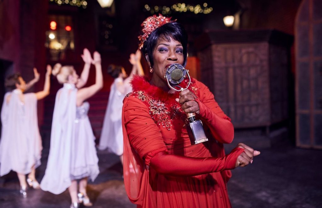 Celestina Warbeck singing Christmas songs in Diagon Alley Wizarding World of Harry Potter. Keep reading to learn about 2023 Harry Potter World Christmas and Christmas at Hogwarts!