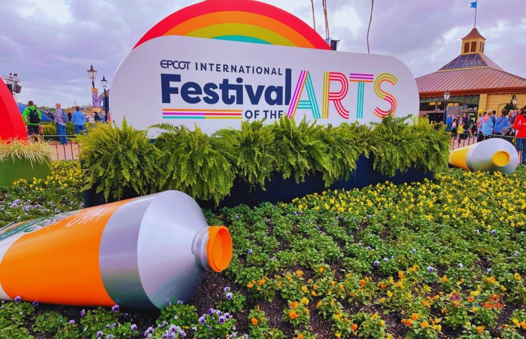 Epcot International Festival of the Arts Large Orange and Yellow Paint over Grass. Keep reading to get the world rides at Epcot for solo travelers on a solo disney world trip.