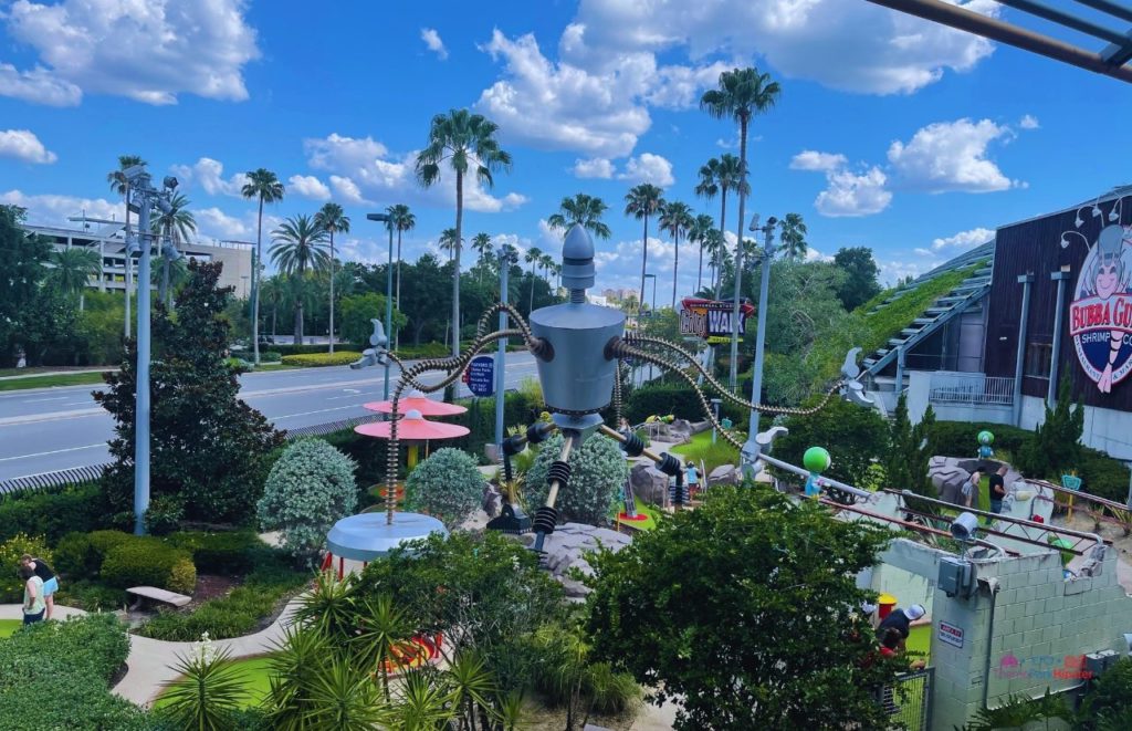 Golfing at Universal Orlando Resort next to Parking Sign. Keep reading to learn about parking at Universal Studios Orlando.