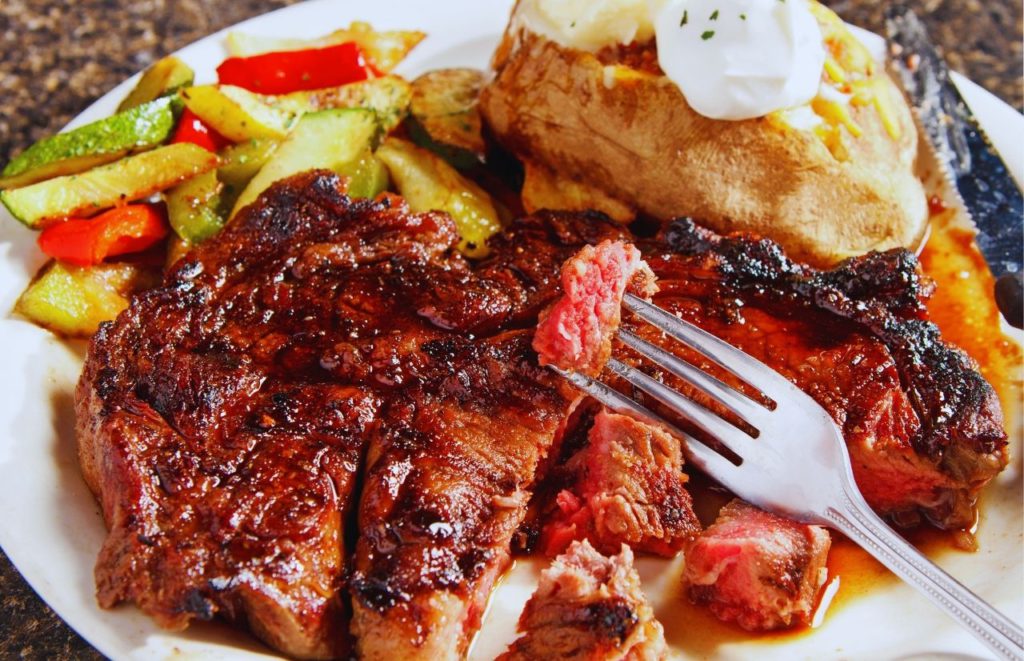 Delmonico’s Italian Steakhouse Steak Meal with Loaded Potatoes. Keep reading to get the best restaurants near SeaWorld Orlando.