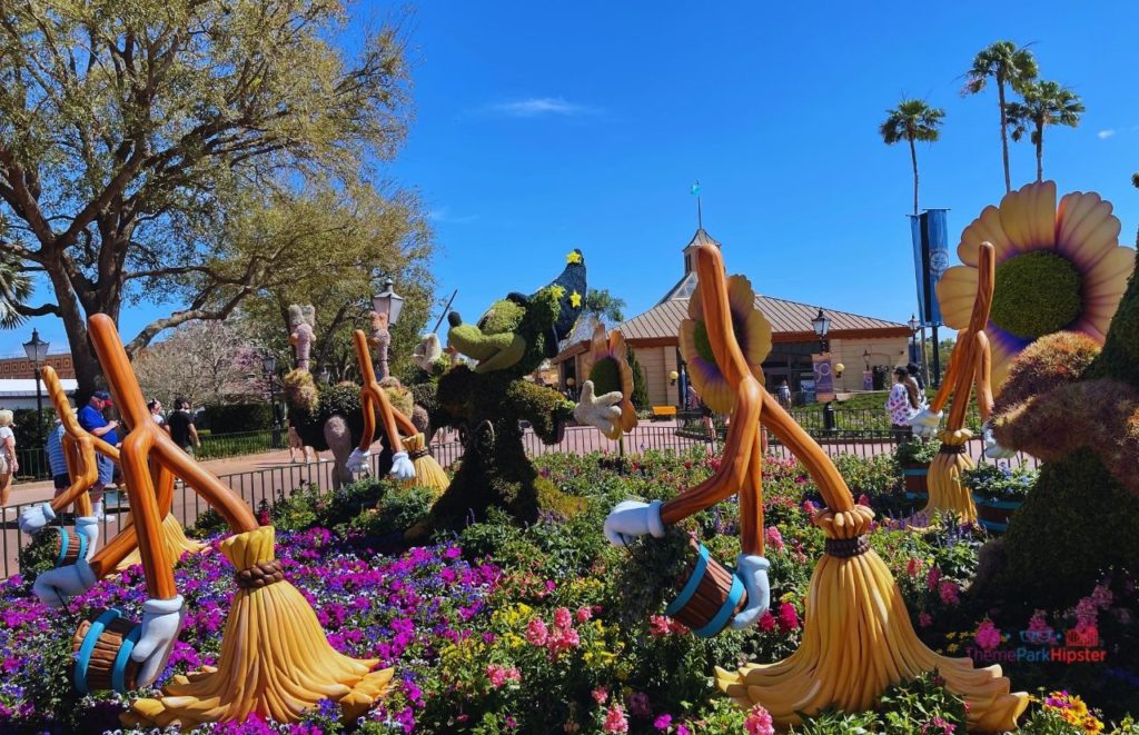 2024 Epcot Flower and Garden Festival Mickey Mouse Fantasia Topiary. Keep reading to learn how to go to Epcot Flower and Garden Festival alone and how to have the perfect solo Disney World trip.