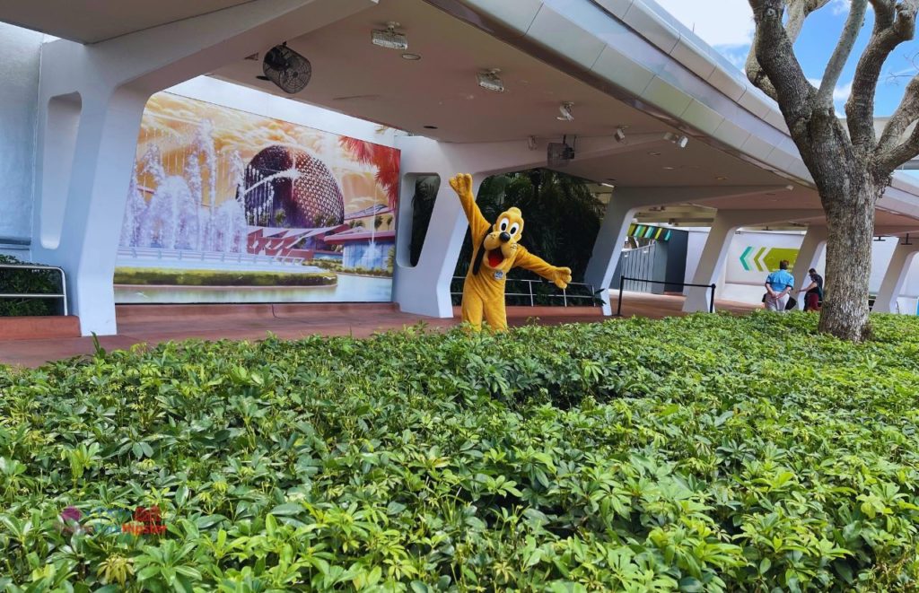 Pluto in fronts of Spaceship Earth mural at Epcot