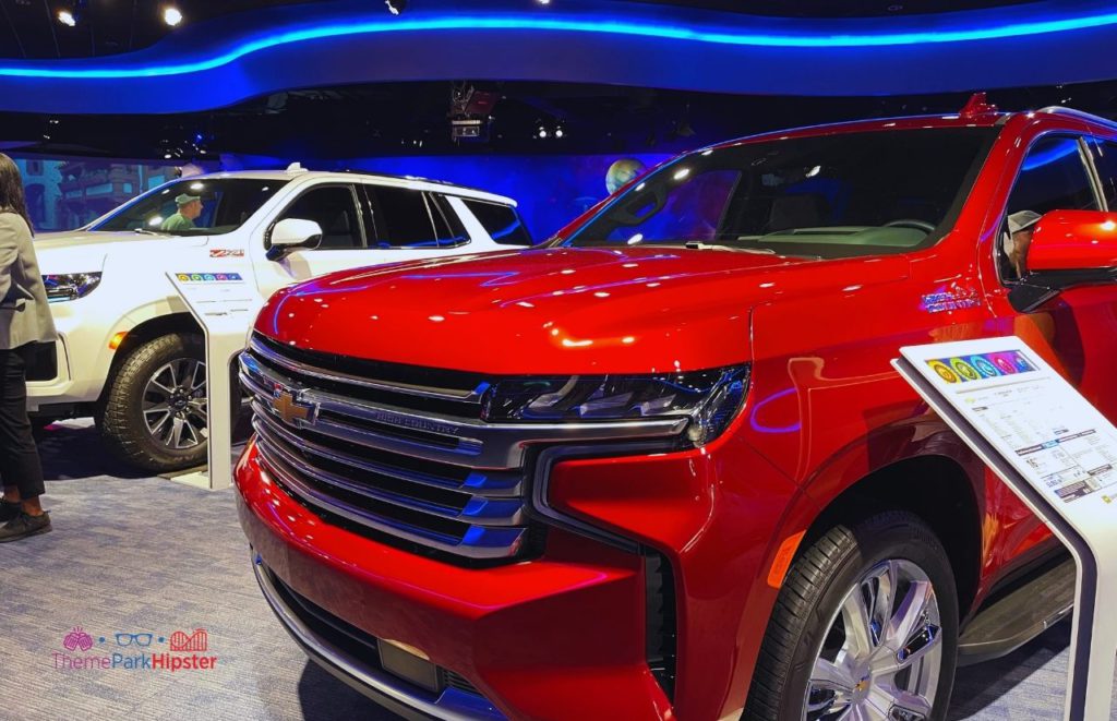 Test Track Epcot Chevrolet Showroom Area with Red Suburban and White Tahoe Showroom. One of the best thrill rides at Disney World.