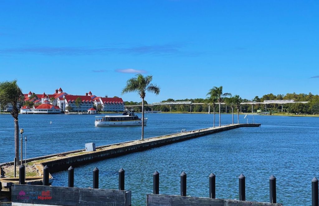 Disney Magic Kingdom Boat on Bay Lake Lagoon overlooking Grand Floridian Resort. Keep reading to get the ultimate guide on the best monorail resorts at Disney World.