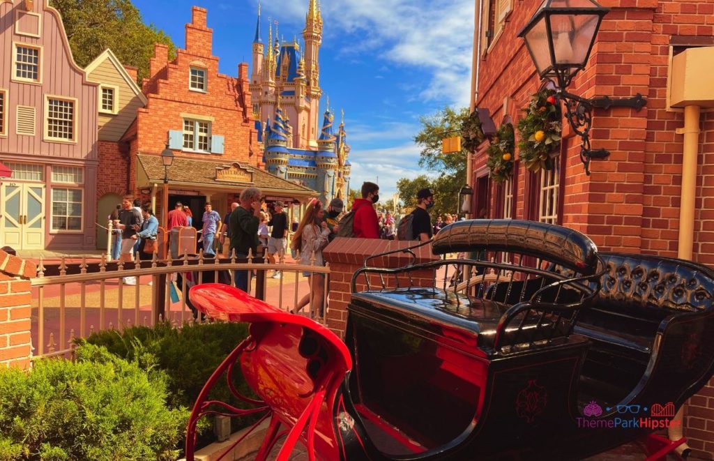 Disney Magic Kingdom Ye Olde Christmas Shoppe in Liberty Outside with Santa sleigh in front of Cinderella Castle