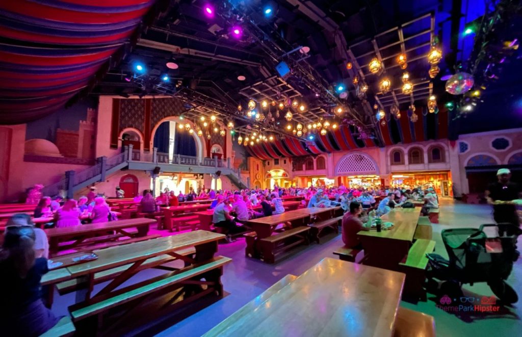 Open dining hall in Pantopia with lots of bench and table seating at Busch Gardens Tampa Bay. Keep reading discover more about what to eat at Busch Gardens Tampa.