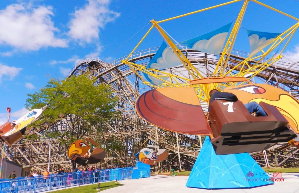 Cedar Point Gemini Roller Coaster behind kiddie ride. Keep reading to get the full guide on the Cedar Point Season Pass Benefits and Cost.