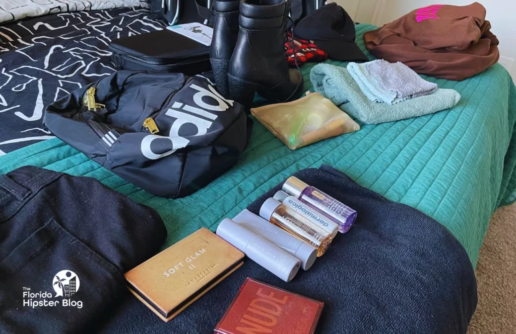 My clothes laid out on the bed for my theme park packing list. Keep reading to find out more about the best things to know before a Disney vacation. 