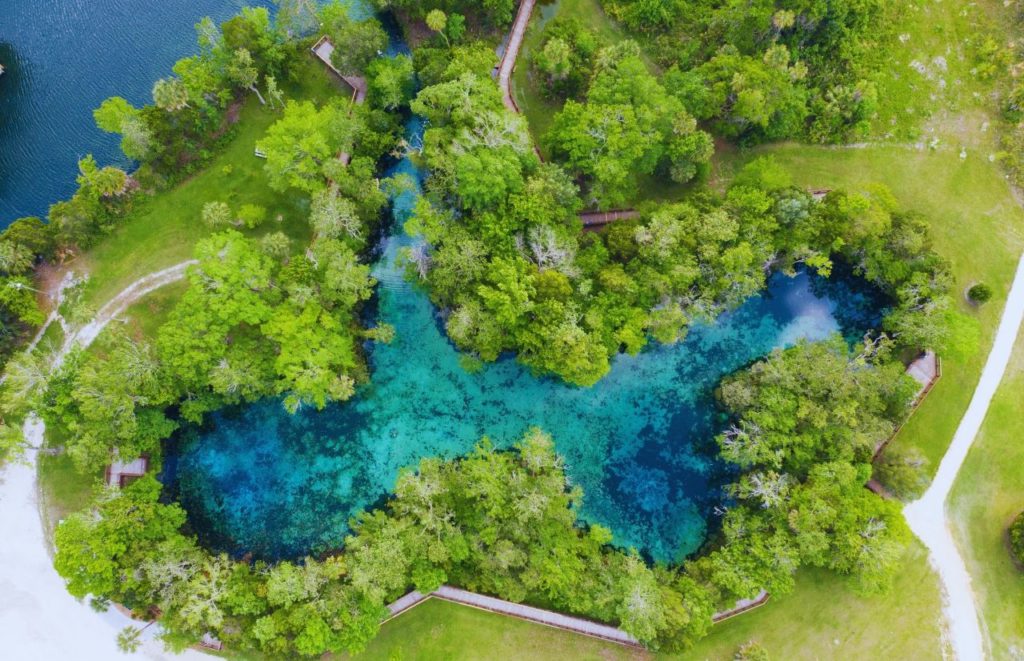 Aerial view of all the nature and crystal clear water at Crystal River Florida. Keep reading to discover the best places to travel solo in Florida.  