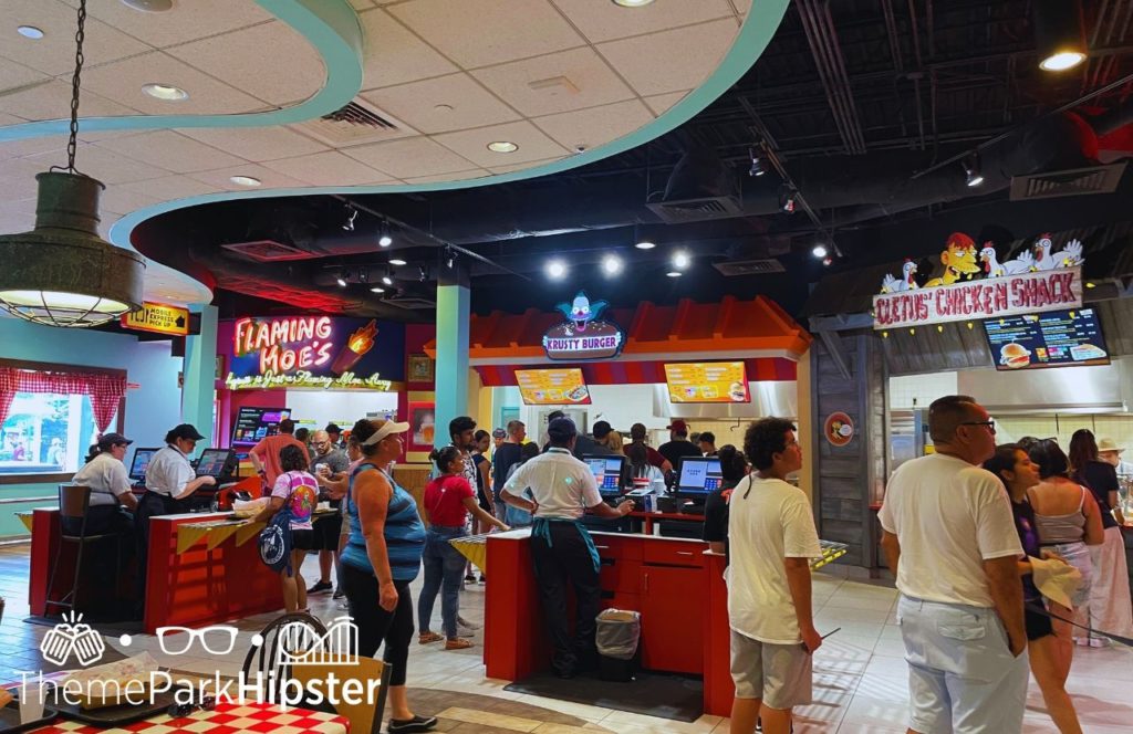 Universal Orlando Resort Simpsons Land Food Court with Flaming Moe's Krusty Burger and Cletus Chicken Shack at Universal Studios Florida. Keep reading to get the best photos at Moe's Tavern Universal Studios and the menu.