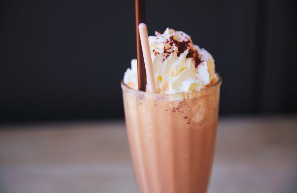 Auntie Gravity's Chocolate Milkshake in Glass with Chocolate shavings and whip cream on Top from Disney Sci Fi Theater in Hollywood Studios