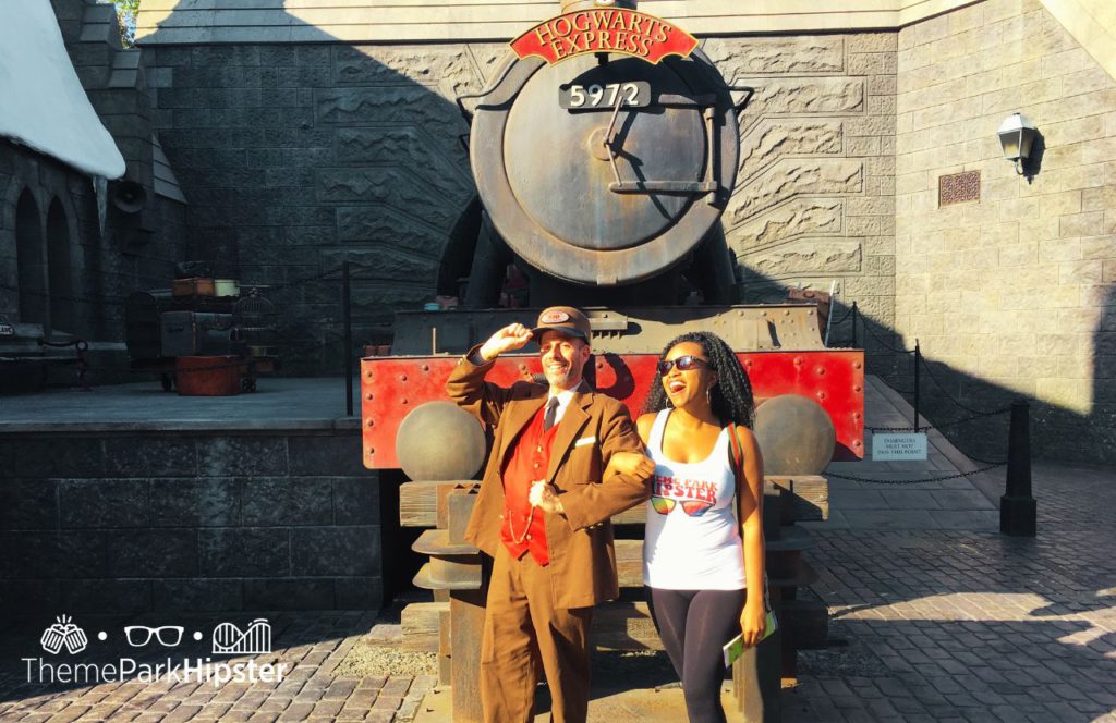 NikkyJ in front of Hogwarts Express Harry Potter World Universal Studios Hollywood California. Keep reading to get your ultimate solo theme park planning guide.