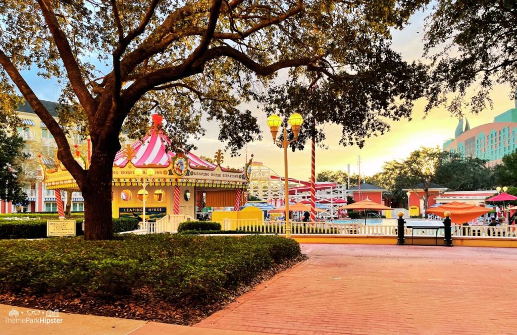 Christmas at Disney Boardwalk Inn and Villas Leaping Horse Libations bar at pool with Swan Resort in background. Keep reading to know what to pack and what to wear to Disney World in June for your packing list.