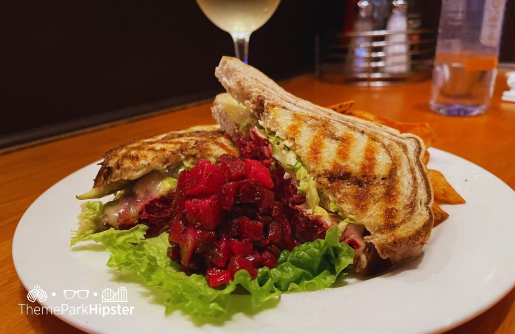 Universal Orlando Resort Finnegan's Irish Pub at Universal Studios Reuben Sandwich with wine. Keep reading to get the top 5 best restaurants at Universal Studios Orlando.