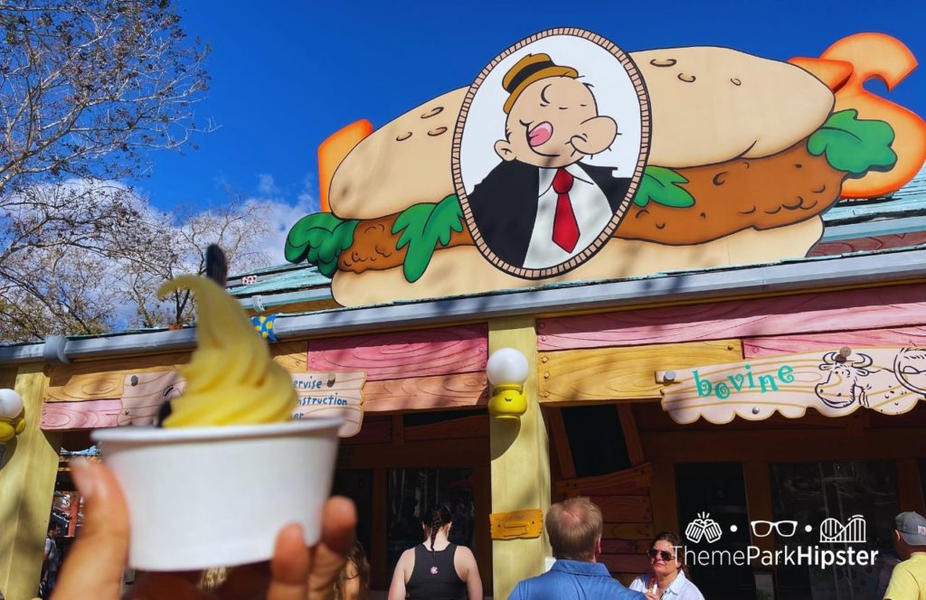 Universal Orlando Resort eating Dole Whip at Wimpy's in Islands of Adventure Toon Lagoon. Keep reading to get the 5 Cheapest, Best Food at Islands of Adventure UNDER $10.