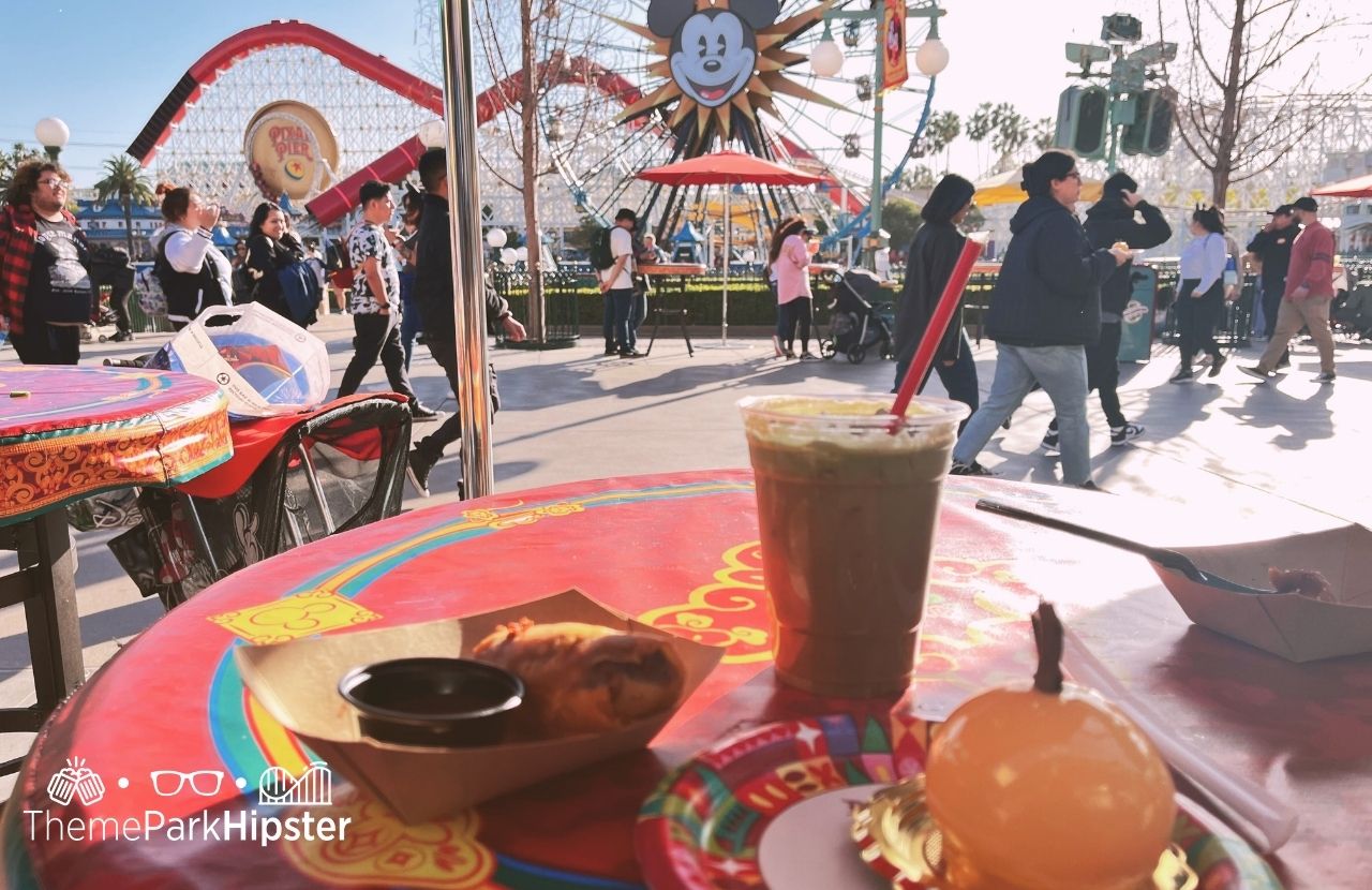 Disneyland Resort Lunar New Year Celebration in Pixar Place at Disney California Adventure Quesabirria Egg Roll, Coconut Lavendar Ice Coffee, Mandarin Mousse Cake. One of the best places to eat at Disneyland.