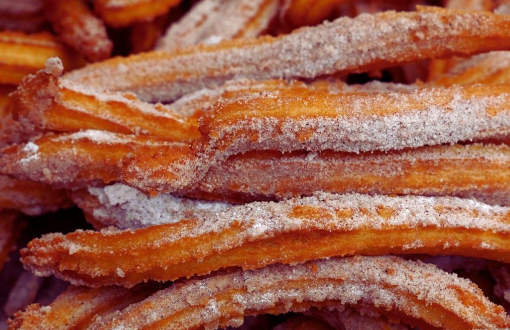 Knott's Berry Farm in California Churros Covered with Sugar. Keep reading to get the best food at Knott's Berry Farm and the best things to eat.