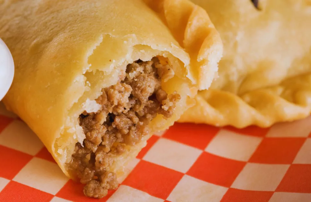 Los Tres Cubanos Empanada Food Truck with it open showing filling. Some of the best food at Hersheypark.