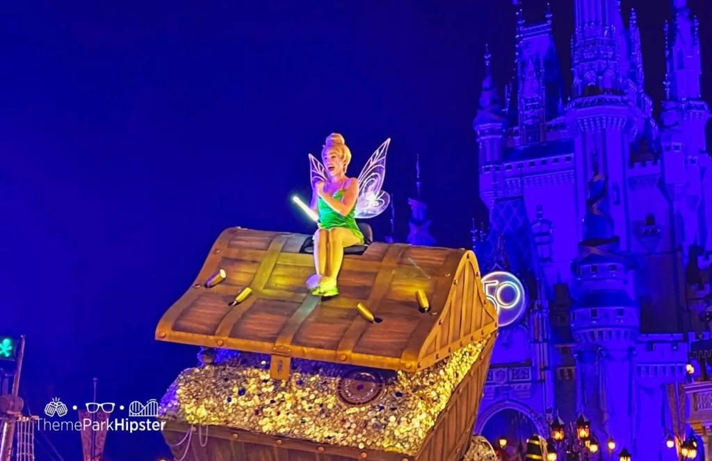 Mickey's Not So Scary Halloween Party at Disney's Magic Kingdom Theme Park Boo to You Halloween Parade in front of Cinderella Castle with character Tinker Bell. Keep reading to see why solo disney trips are fun.