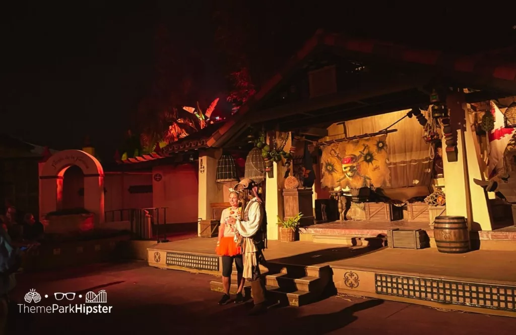 Mickey's Not So Scary Halloween Party at Disney's Magic Kingdom Theme Park Jack Sparrow with guest next to the Pirates of the Caribbean ride in Adventureland character meet and greet.