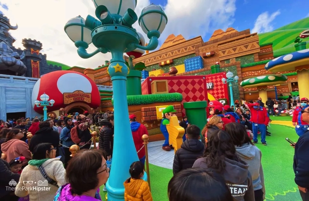 Universal Studios Hollywood Super Nintendo World Luigi and Mario walking next to Toadstool Cafe