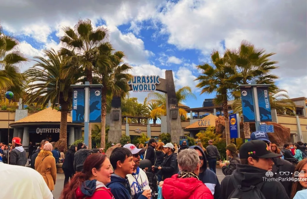 Universal Studios Hollywood entrance to Jurassic World on crowded day. Keep reading to learn more about the Universal Studios Hollywood VIP Experience. 