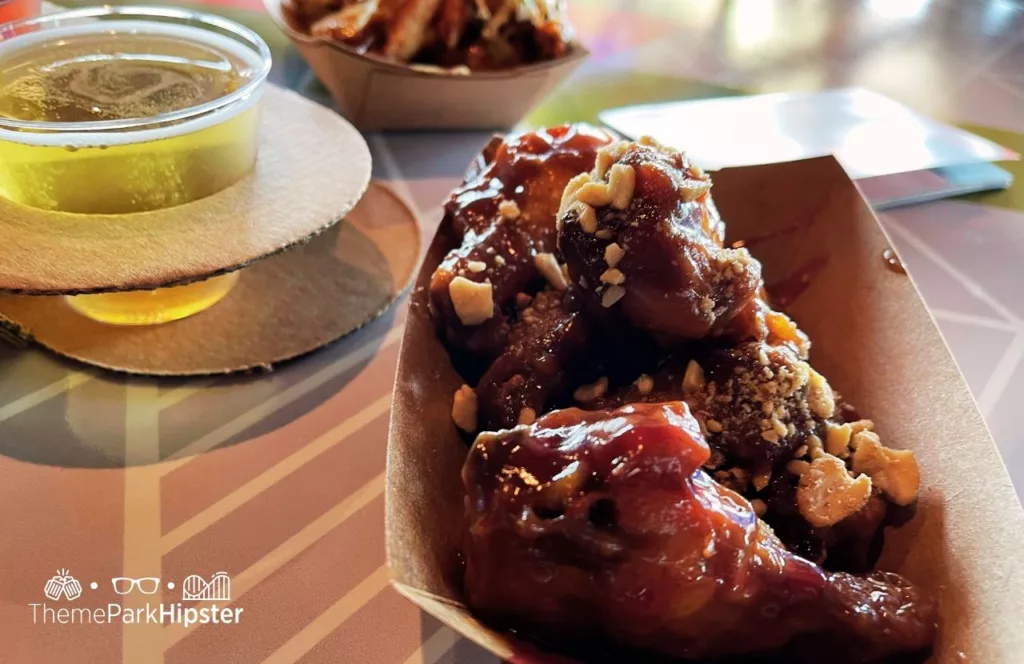 2023 Epcot Food and Wine Festival at Disney Odyssey Cider Flight with Parmesan and Peanut Butter and Jelly Chicken Wings