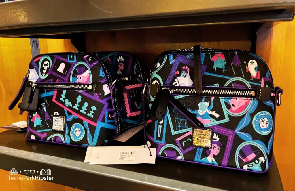 Disney Memento Mori Store Haunted Mansion Merchandise at Magic Kingdom Theme Park Dooney and Burke Purse. One of the best crossbody bags for Disney World.