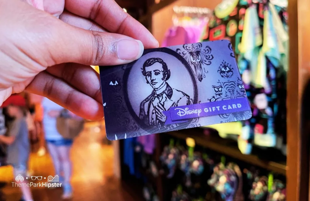 Disney Memento Mori Store Haunted Mansion Merchandise at Magic Kingdom Theme Park Master Grady Gift Card. Keep reading to see how much it cost to go to Disney World and how to save for your trip.