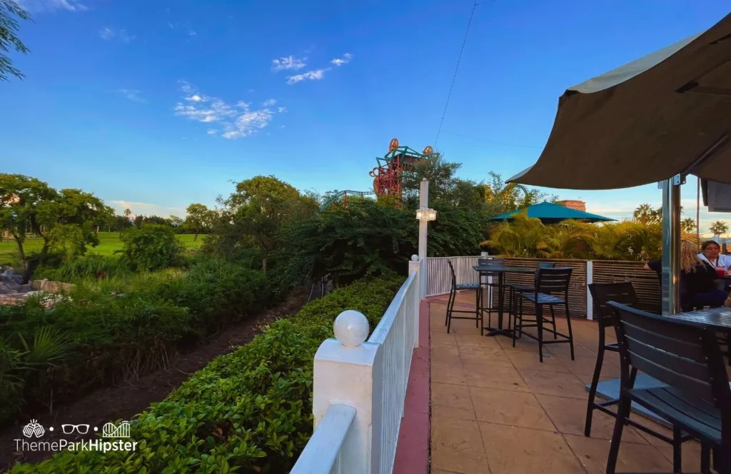 Balcony view of Serengeti Safari with outdoor seating and umbrellas at  from Giraffe Bar at Busch Gardens Tampa Bay. Keep reading to find out more about what to eat at Busch Gardens Tampa.