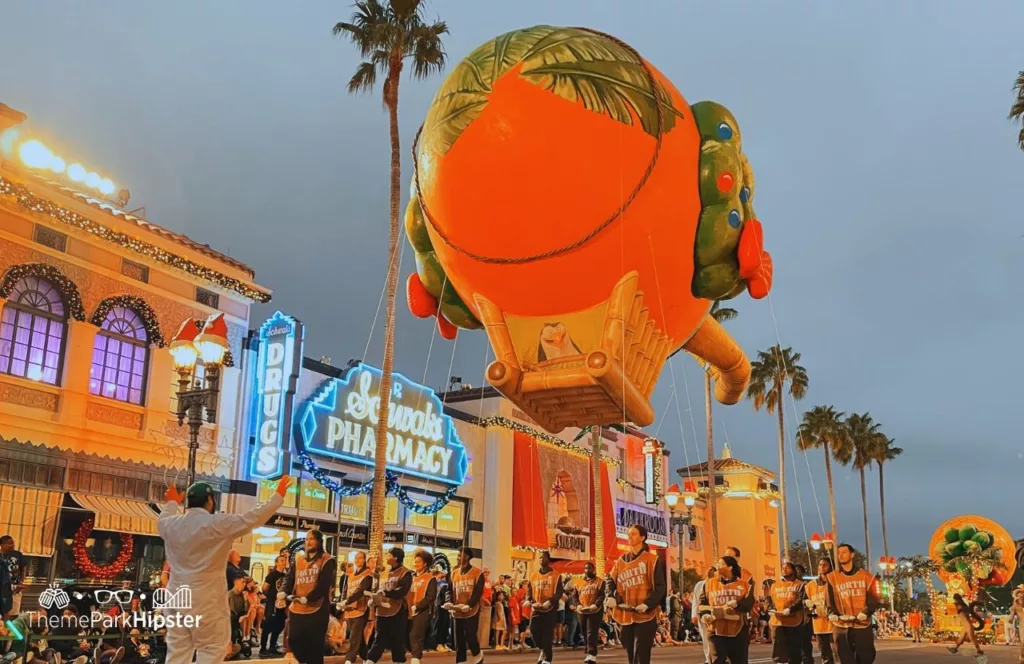 Christmas at Universal Orlando Holiday Parade featuring a larger than life balloon character. Keep reading to discover more about Christmas parade at Universal Studios Florida. 