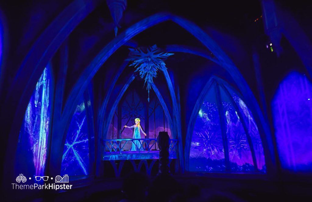 Queen Elsa on Frozen Ever Ride at Epcot in Norway Pavilion Disney World. Keep reading to get the best Disney Christmas songs!