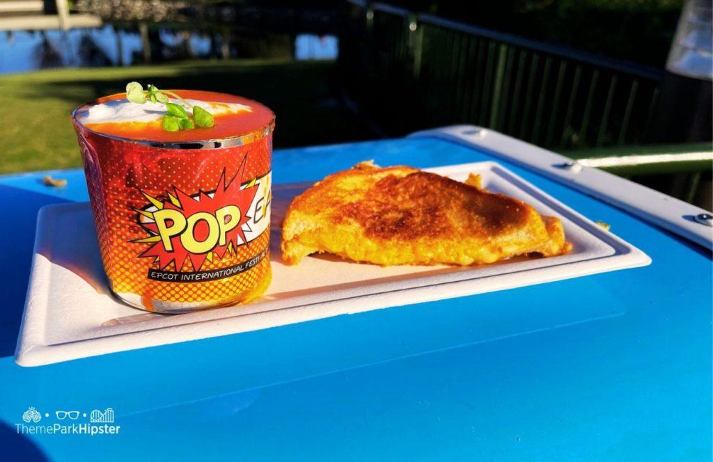 Epcot Festival of the Arts Disney World Pop Eats Food Tomato Soup and Grilled Cheese. Keep reading the get the worst and best snacks at Disney World.