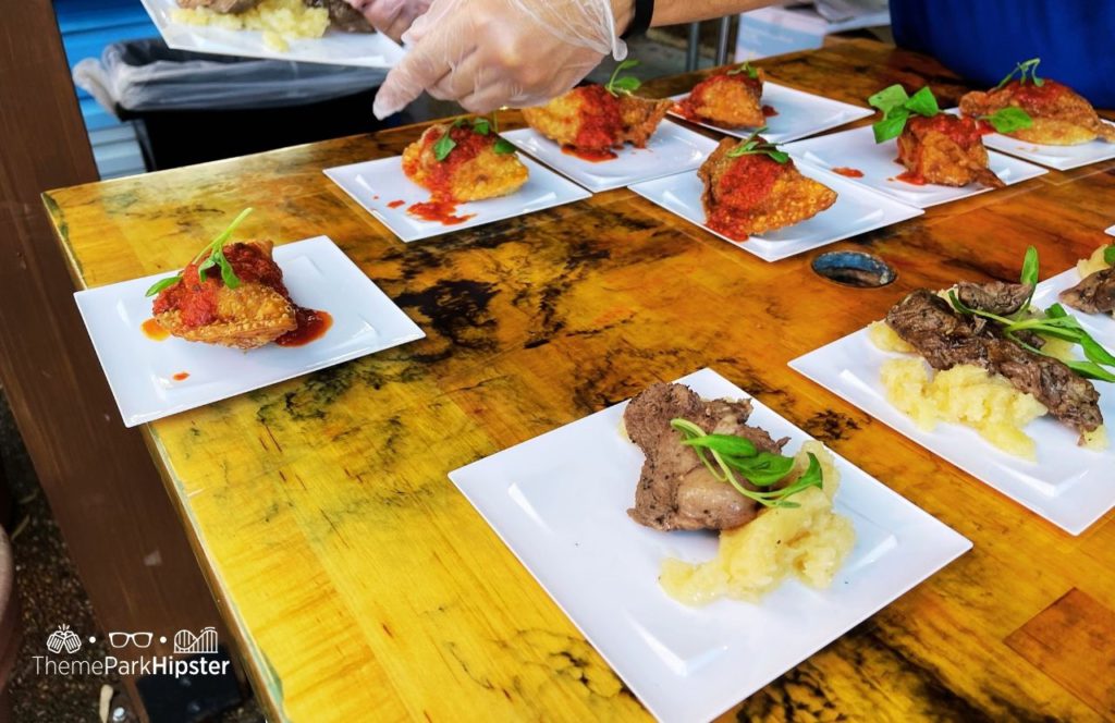 Busch Gardens Tampa 2024 Food and Wine Festival Argentina Booth with Empanada and Beef. One of the best things to eat at Busch Gardens Food and Wine Festival.