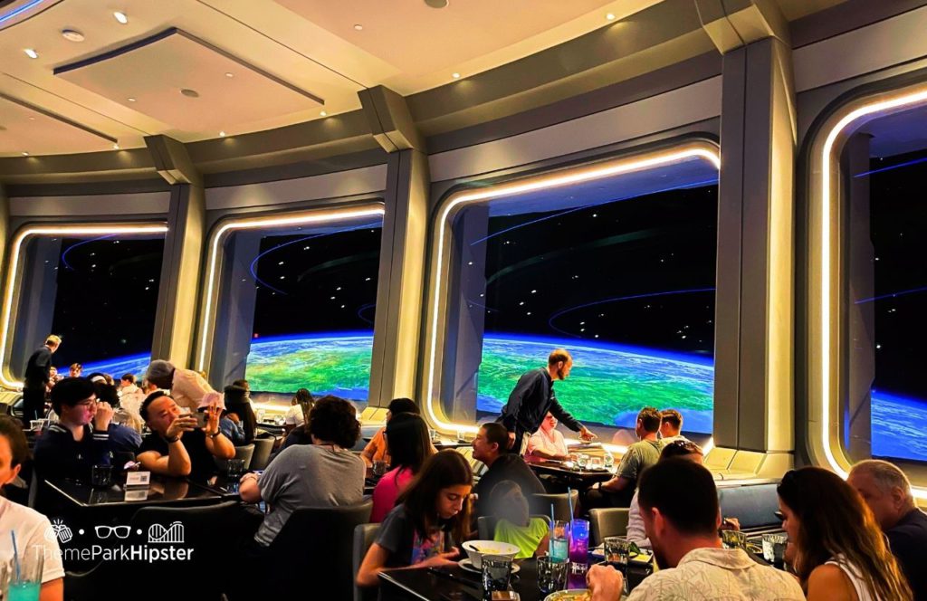 Space 220 Restaurant at Epcot in Walt Disney World dining room. One of the best restaurants at Epcot. Keep reading to learn more about the best things to know before a Disney vacation.