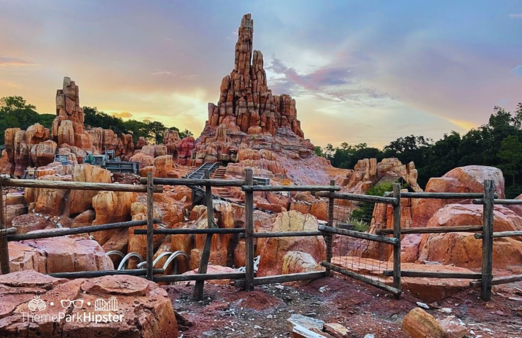 Disney Magic Kingdom Park Frontierland Big Thunder Mountain Railroad Roller Coaster at Sunset. Keep reading to learn How to Find the BEST Disney Travel Agent and Why You NEED One!