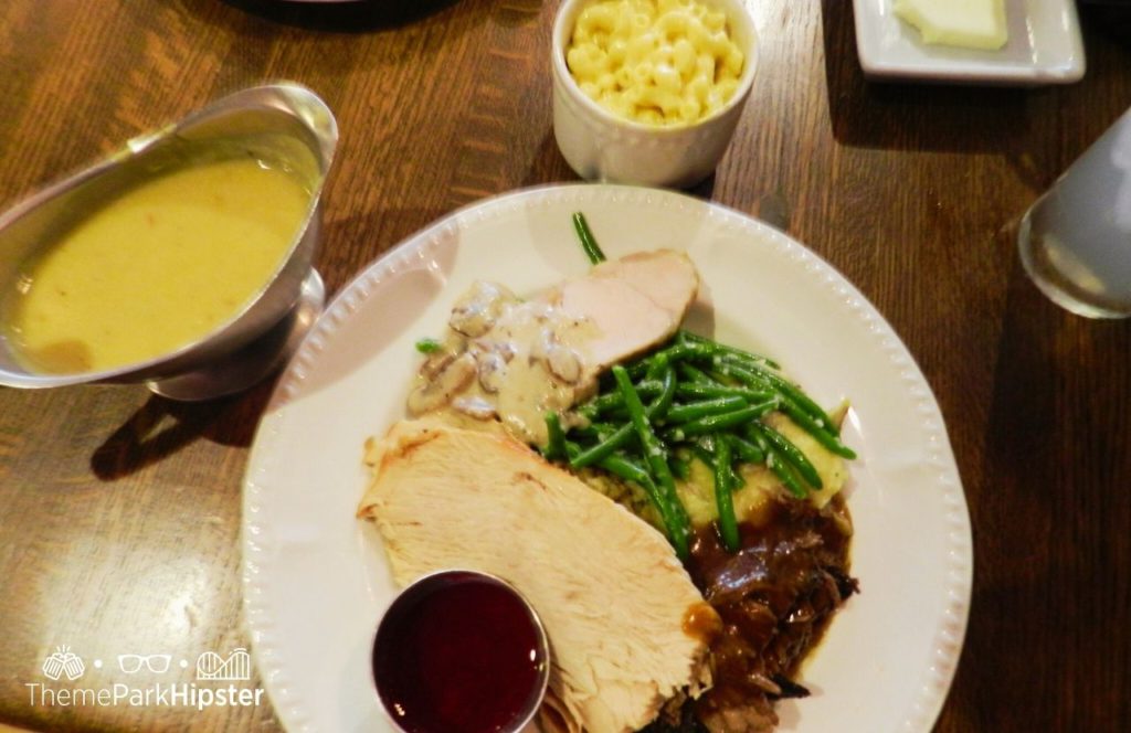 Disney Magic Kingdom Park Liberty Tree Tavern Restaurant with roast beef turkey gravy green beans and mac and cheese. One of the best restaurants at Magic Kingdom.