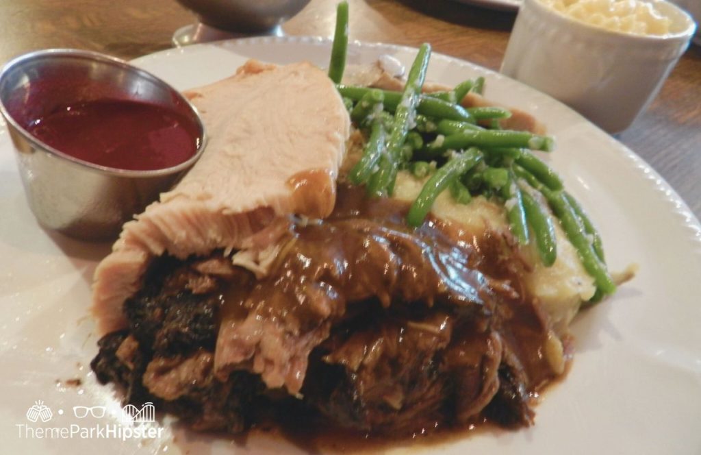 Disney Magic Kingdom Park Liberty Tree Tavern Restaurant with roast beef turkey gravy green beans and mac and cheese. Keep reading to find out more about the best buffet in Disney World.